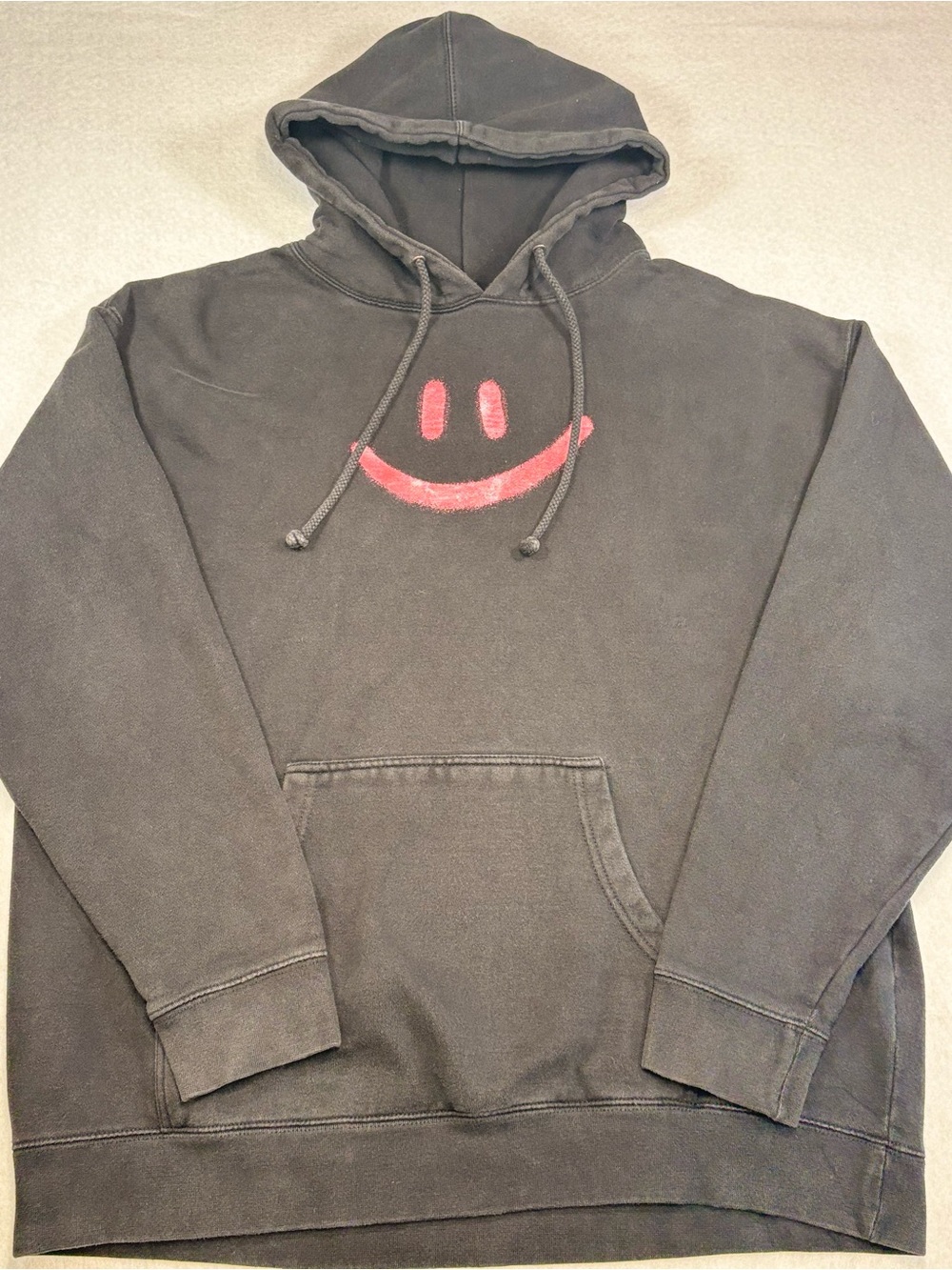 Black Hoodie with Red Smiley Graphic